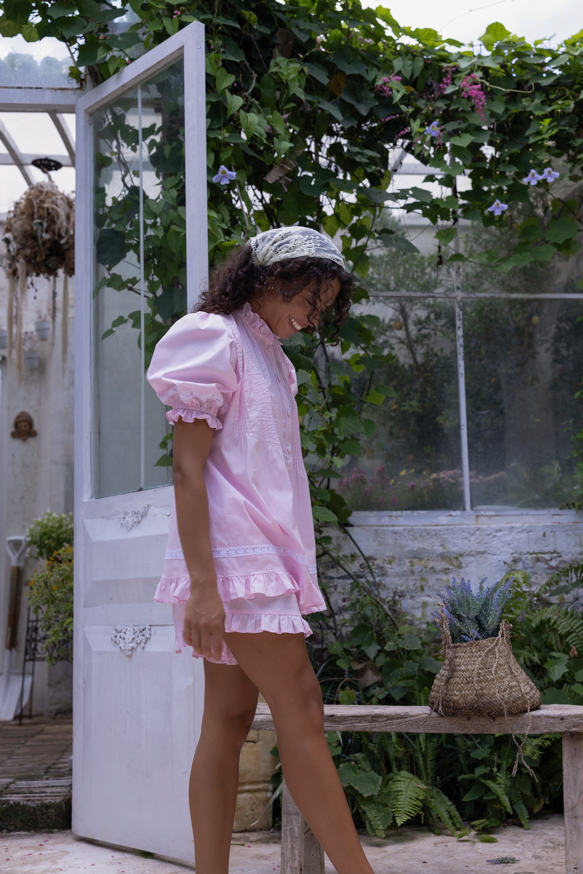 Alma Blossom Set in pink cotton with pin-tuck pleats, covered buttons and white eyelet lace trim, styled in a garden by Love Letters x