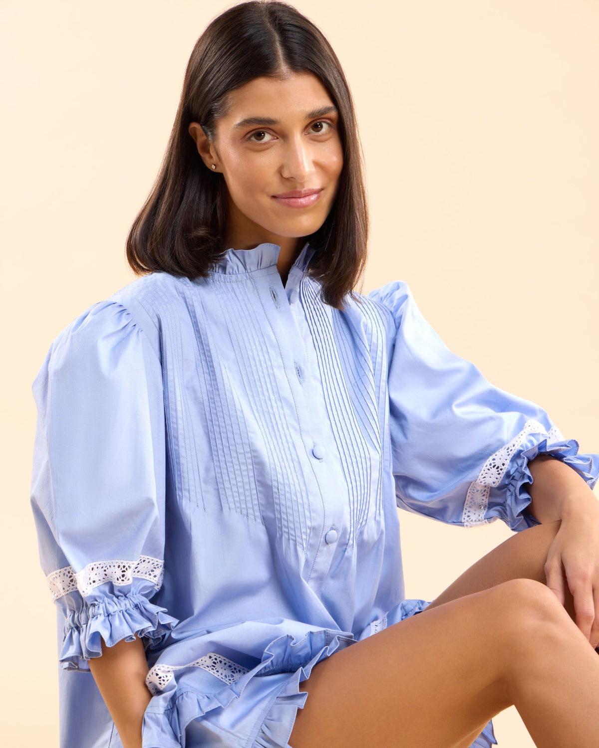 Close-up of the Alma Bluebelle Set frilled collar, puff sleeves and eyelet lace cuffs in periwinkle blue cotton