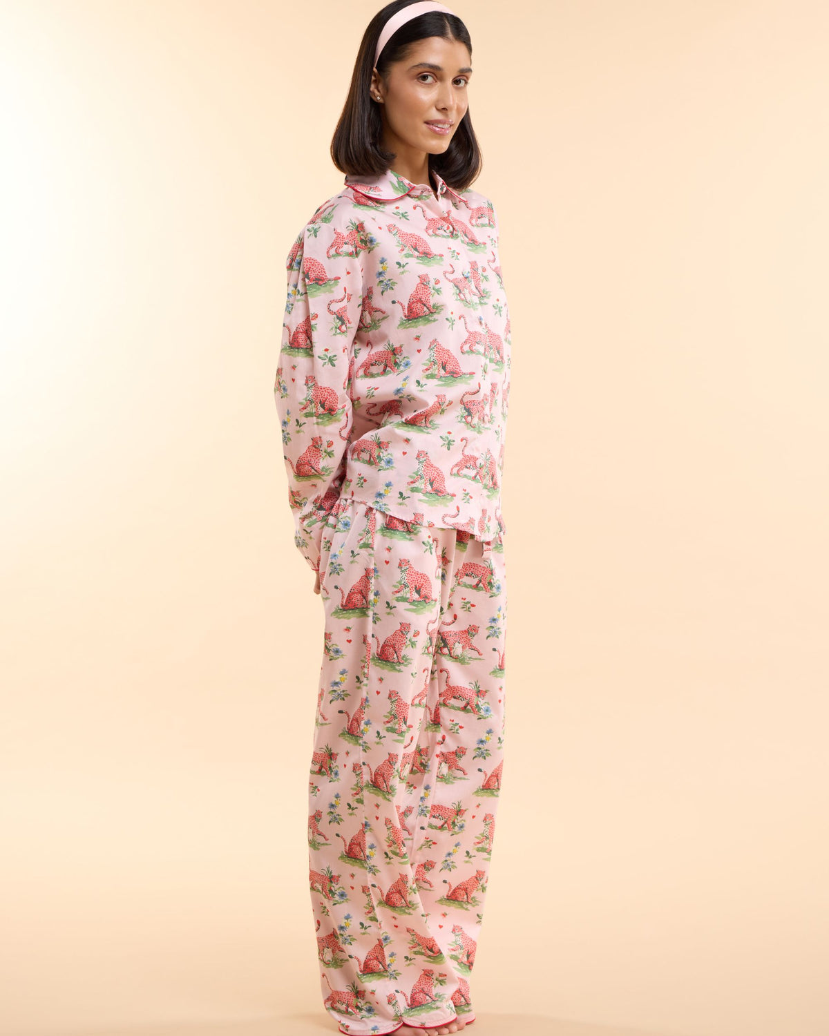 Side view of the Layla Pink long pyjama set in blush pink leopard and floral print cotton with coral piping