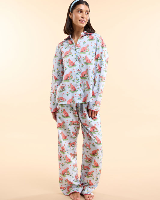 Model wearing the Layla Blue Long PJ Set, a powder blue cotton pyjama set with pink leopard print and coral piping, by Love Letters x