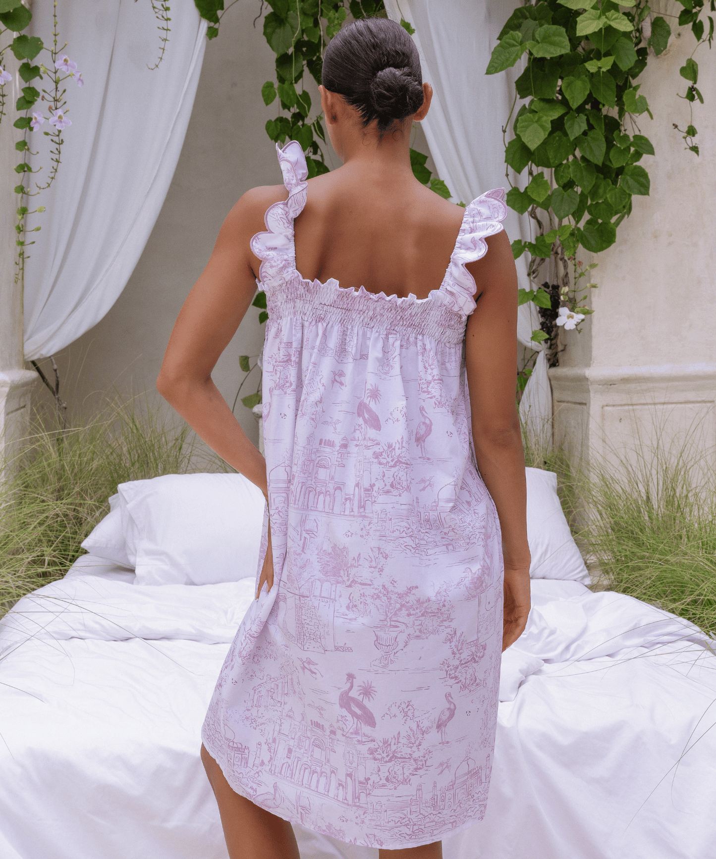 Woman wearing Pink Toile nightdress styled in romantic garden setting
