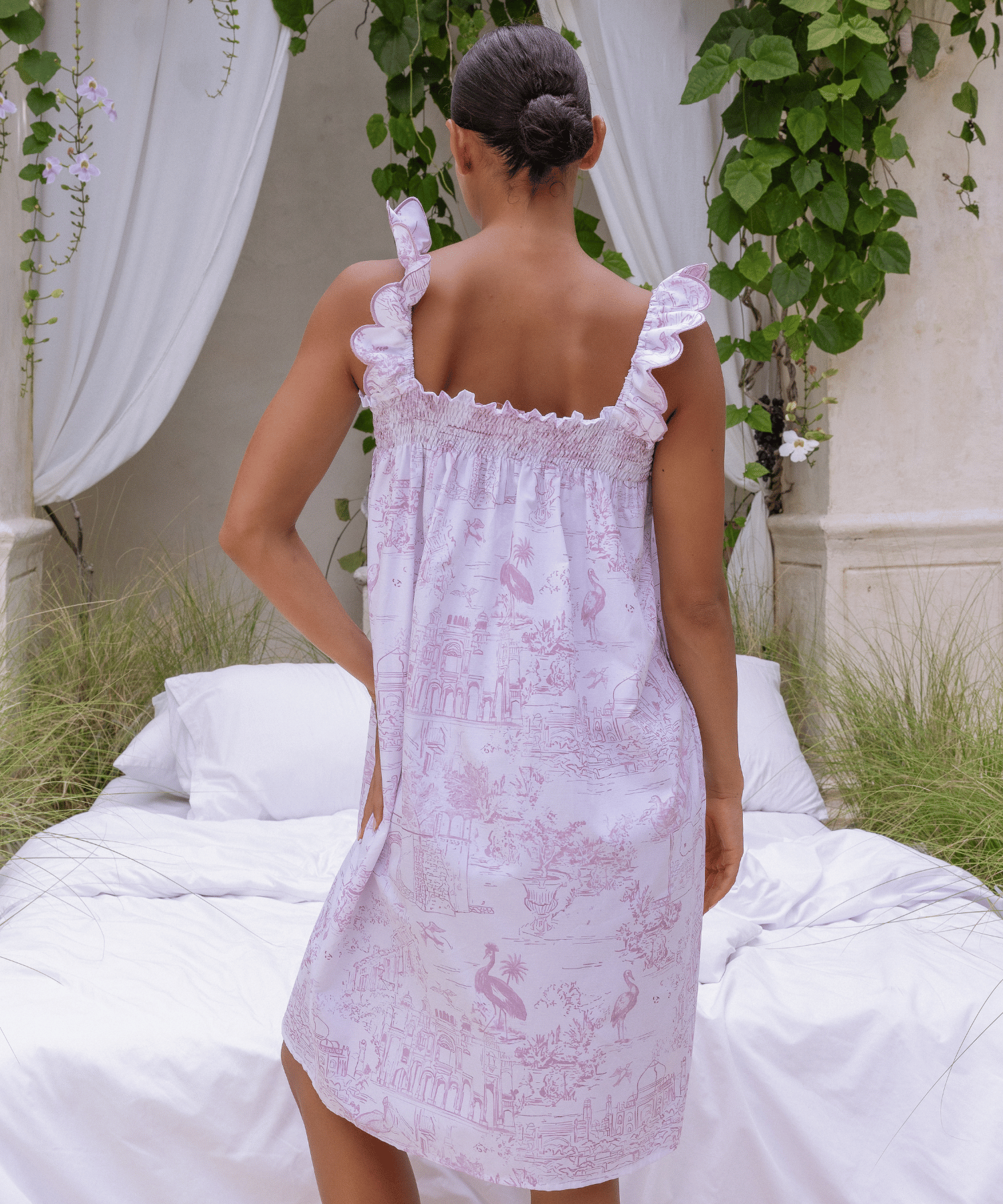Woman wearing Pink Toile nightdress styled in romantic garden setting